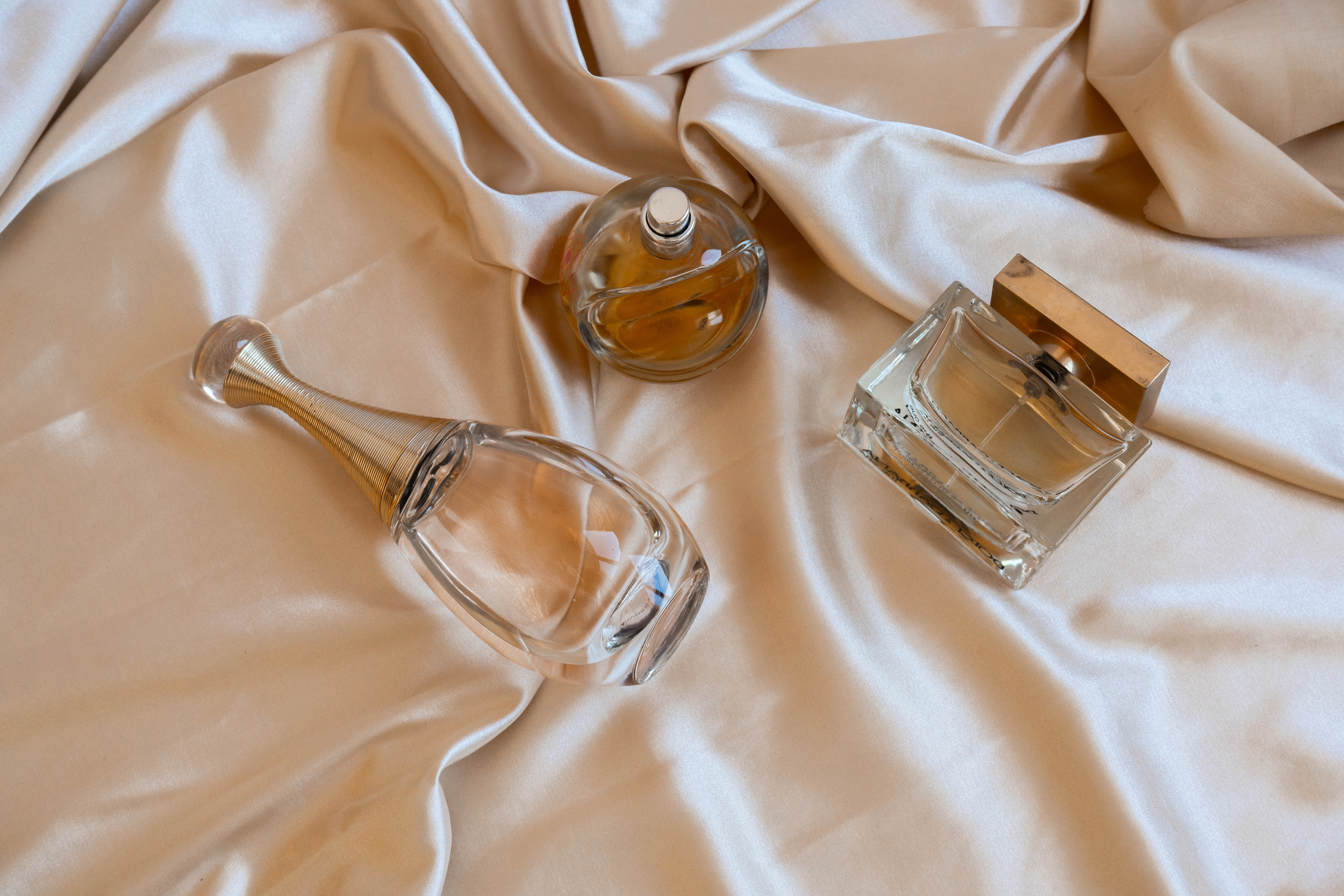 Perfume Bottles on Beige Silk Fabric